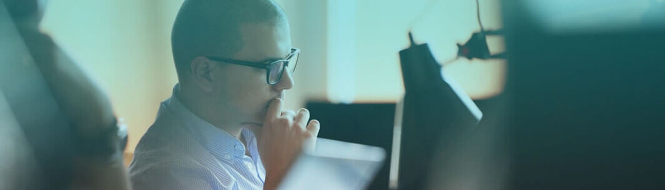 Software developer working on computer at modern office